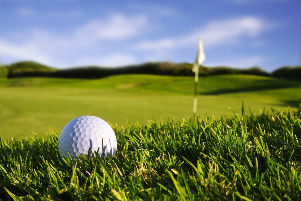 golf ball close up by flagpole