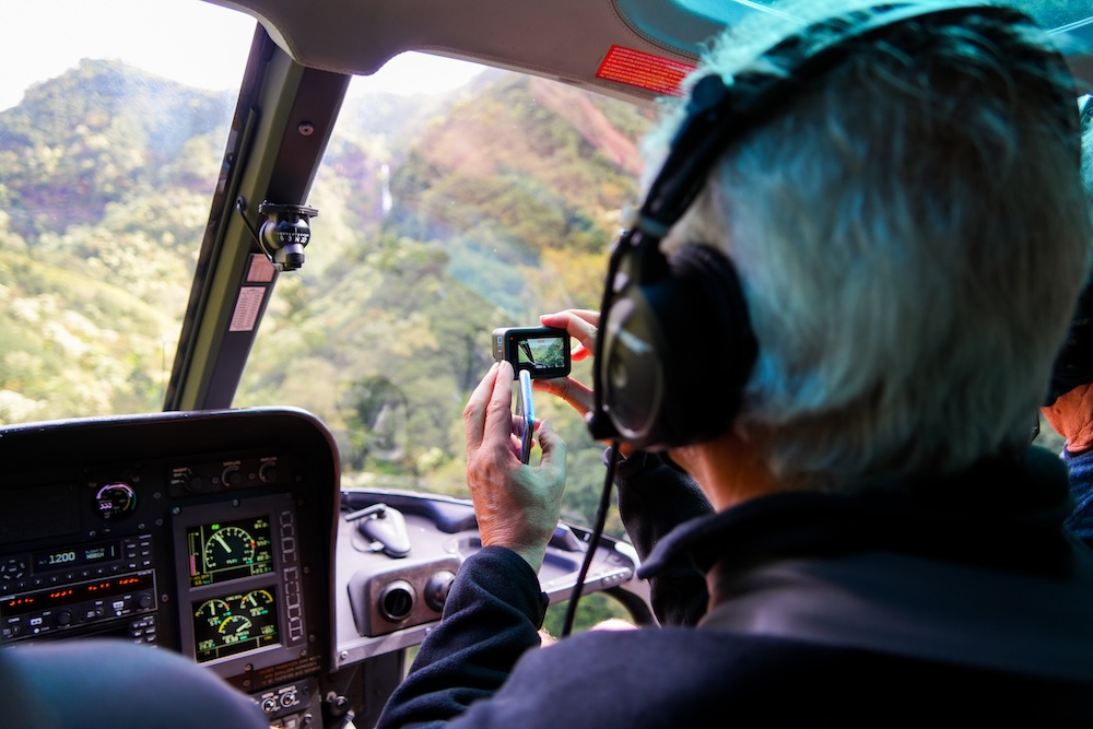 Man taking video from Helicopter on tour over Hawaii