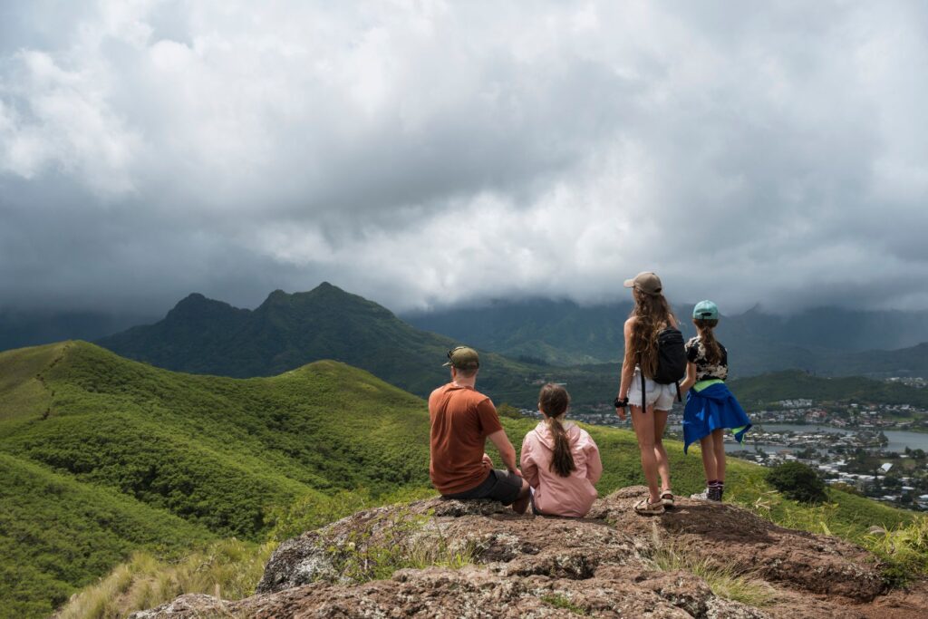 father hiking with family in hawaii
