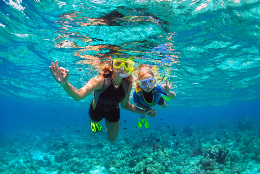 Mom and child snorkeling Hawai'i